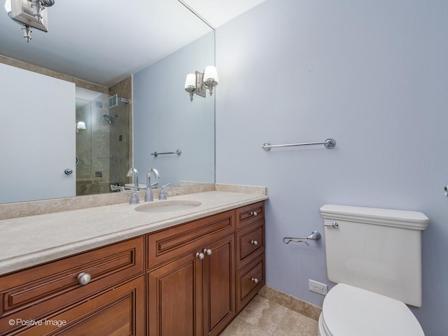 bathroom featuring tile patterned floors, vanity, an enclosed shower, and toilet