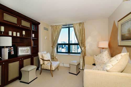 sitting room featuring light colored carpet