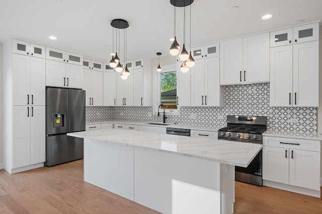 kitchen featuring sink, a center island, white cabinets, and appliances with stainless steel finishes