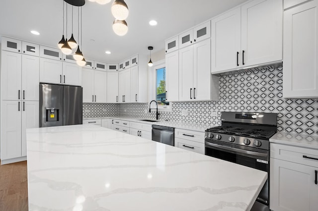 kitchen featuring decorative light fixtures, white cabinetry, and appliances with stainless steel finishes