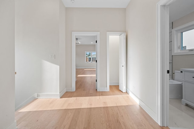 corridor with light hardwood / wood-style flooring