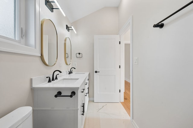 bathroom with vanity, toilet, and vaulted ceiling