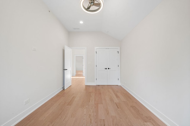 interior space with light wood-type flooring and lofted ceiling