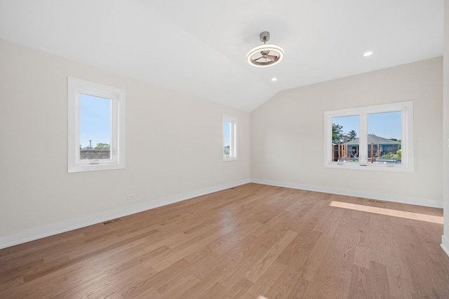 interior space with light hardwood / wood-style floors and lofted ceiling