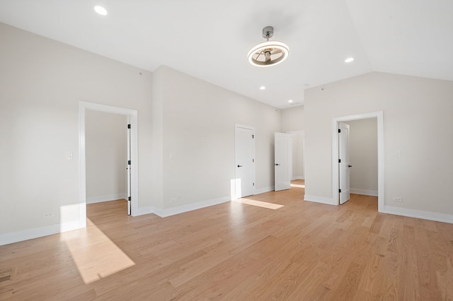 unfurnished bedroom featuring light wood-type flooring and vaulted ceiling