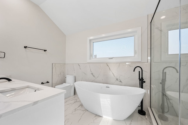 full bathroom featuring vaulted ceiling, shower with separate bathtub, toilet, vanity, and tile walls