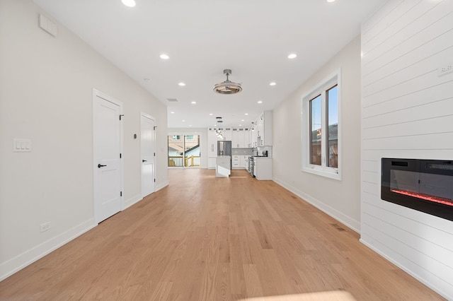 hallway with light hardwood / wood-style flooring