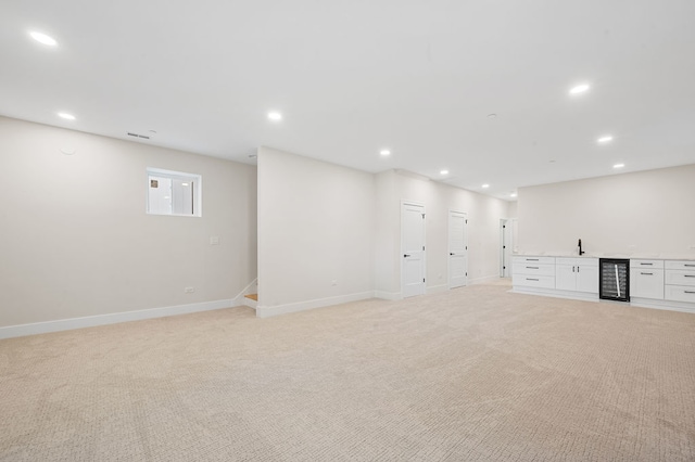 basement with sink and light colored carpet