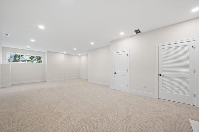 basement featuring light colored carpet