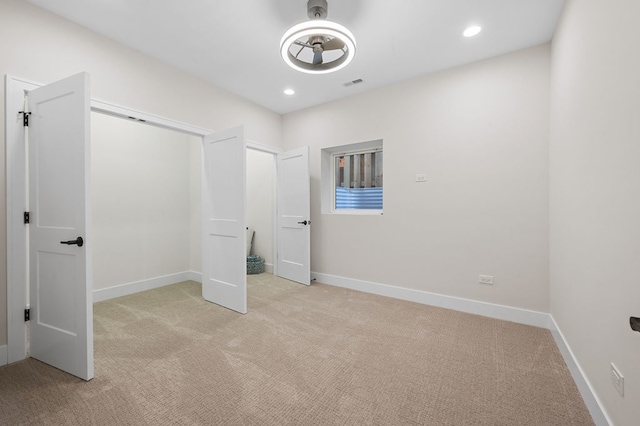 unfurnished bedroom with light colored carpet