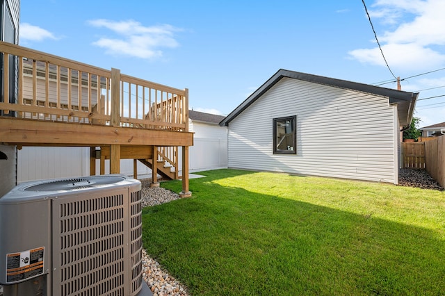 view of yard featuring central AC unit and a wooden deck