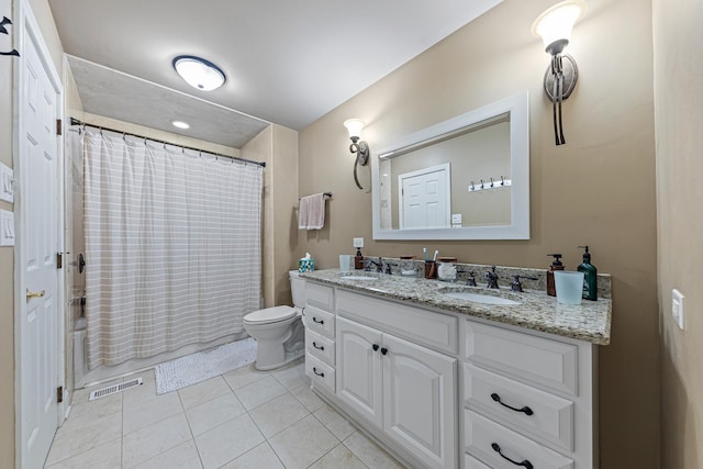 bathroom with tile patterned flooring, vanity, and toilet