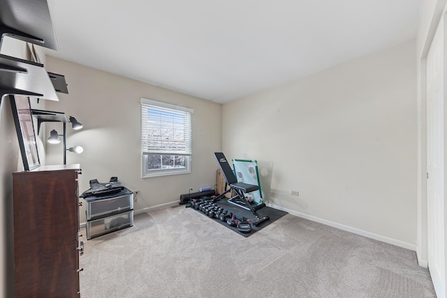 workout room featuring light carpet