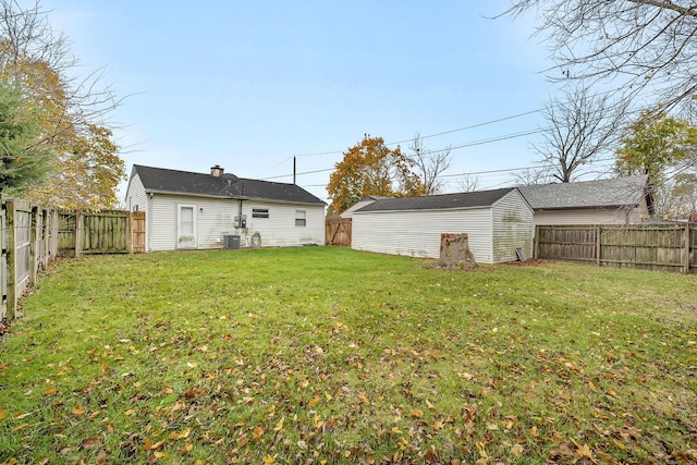 view of yard featuring central AC unit and an outdoor structure