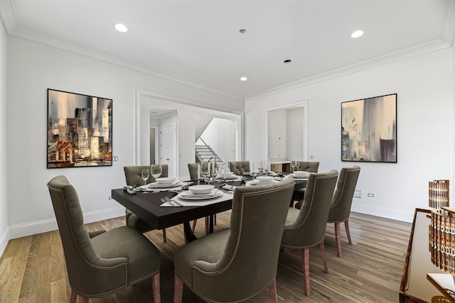 dining area featuring hardwood / wood-style floors and ornamental molding