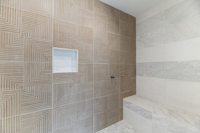 bathroom featuring a shower and tile walls