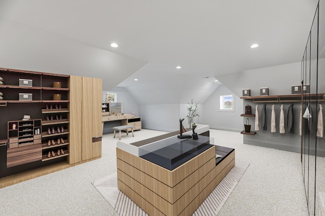 office area with light colored carpet and vaulted ceiling