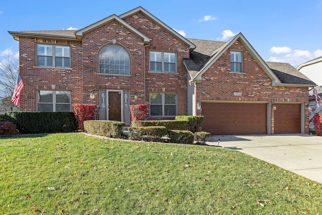 view of front property featuring a garage and a front lawn