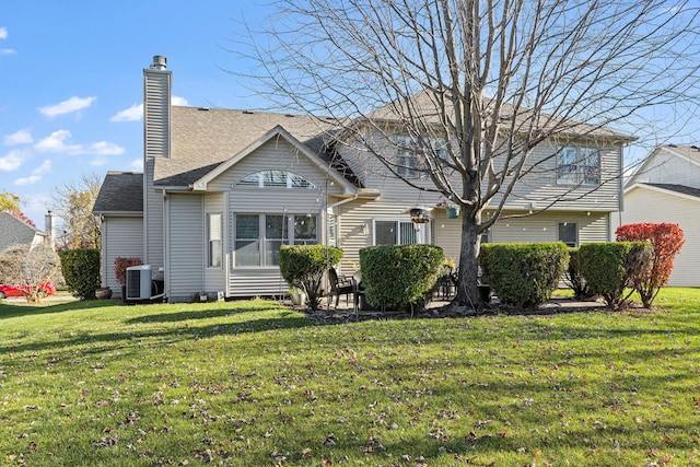 back of house with a yard and central AC unit