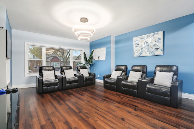 cinema room with dark hardwood / wood-style floors