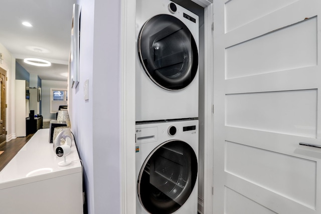 clothes washing area featuring stacked washer and dryer