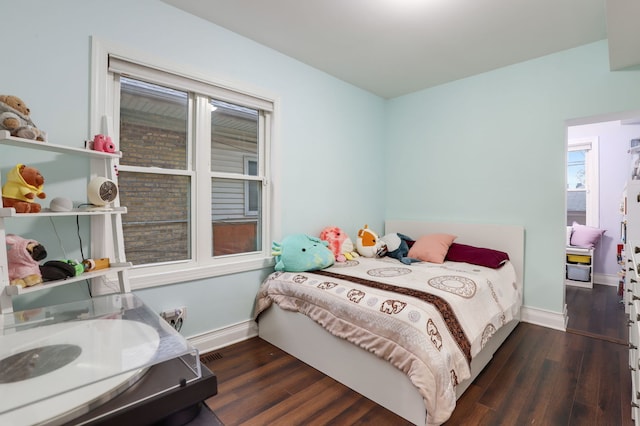 bedroom with dark hardwood / wood-style floors