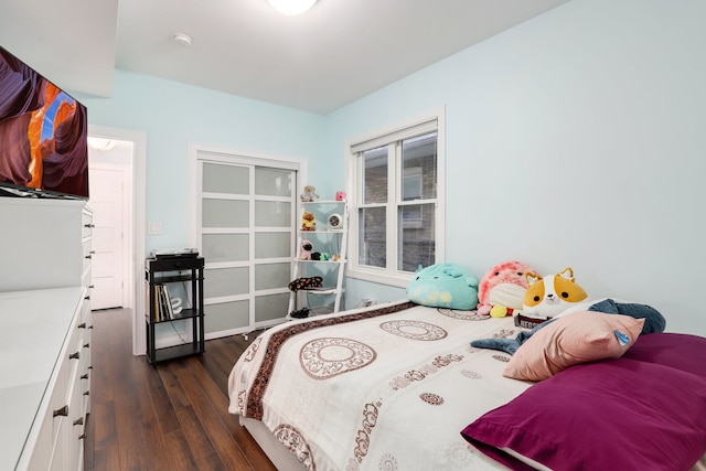 bedroom with dark hardwood / wood-style flooring