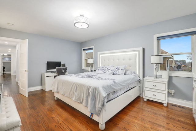 bedroom with dark hardwood / wood-style flooring