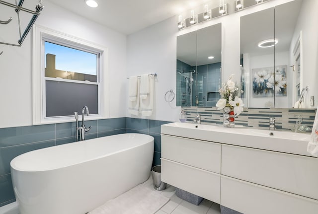 bathroom with tile patterned floors, separate shower and tub, tasteful backsplash, and vanity