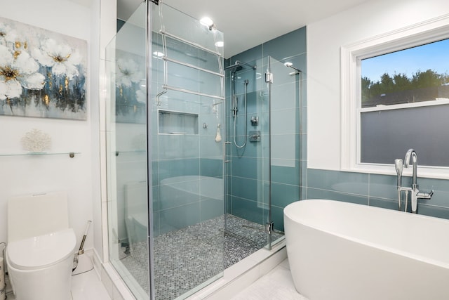 bathroom with separate shower and tub, tile walls, and toilet