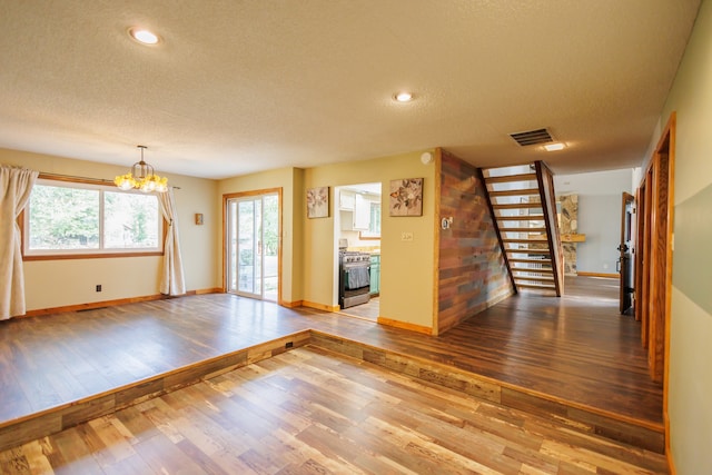 interior space featuring a chandelier, a textured ceiling, and hardwood / wood-style flooring