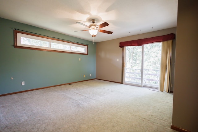 empty room with light carpet, plenty of natural light, and ceiling fan