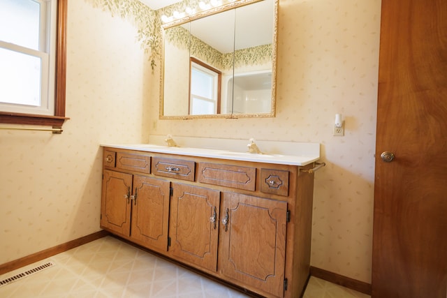 bathroom with vanity and a healthy amount of sunlight