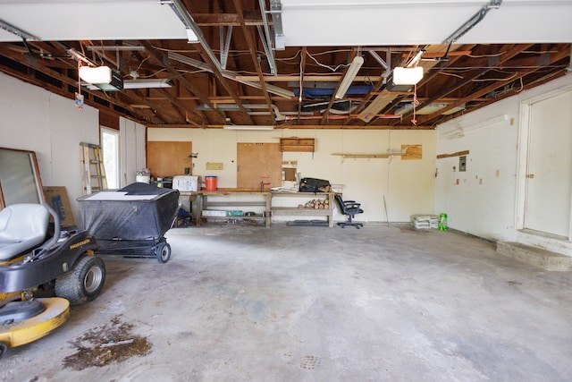 garage with a workshop area and a garage door opener