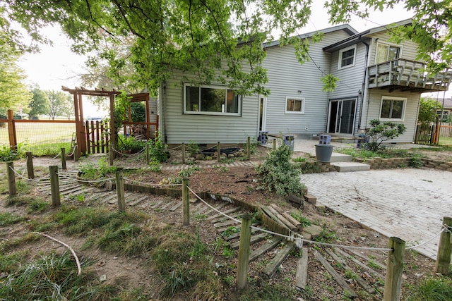 rear view of house with a patio area and a balcony