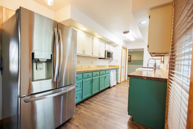 kitchen featuring sink, green cabinetry, dark hardwood / wood-style floors, butcher block countertops, and stainless steel appliances