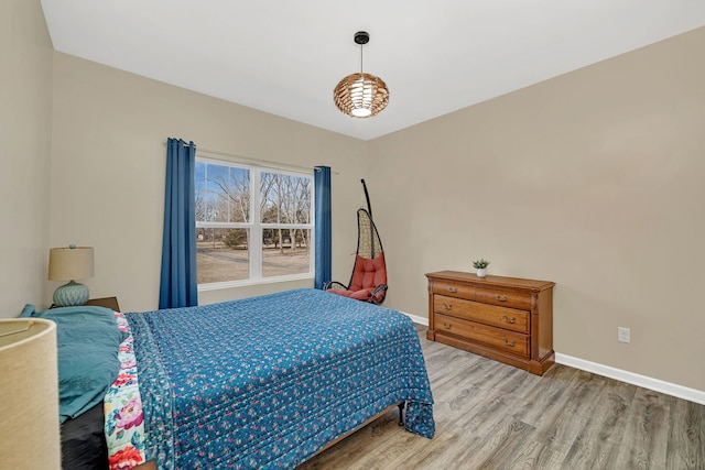 bedroom with light wood-style flooring and baseboards