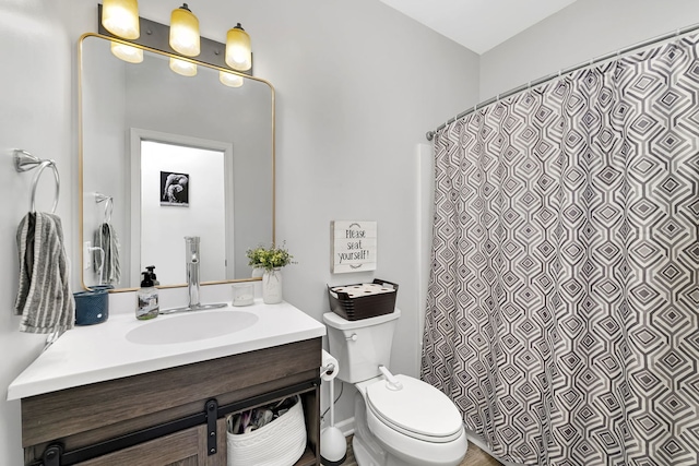 bathroom featuring curtained shower, vanity, and toilet