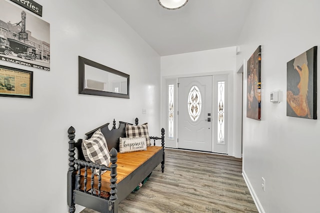 entryway with baseboards and wood finished floors