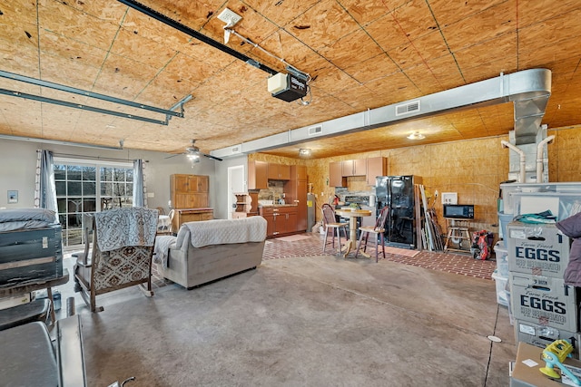 garage with ceiling fan, visible vents, and a garage door opener