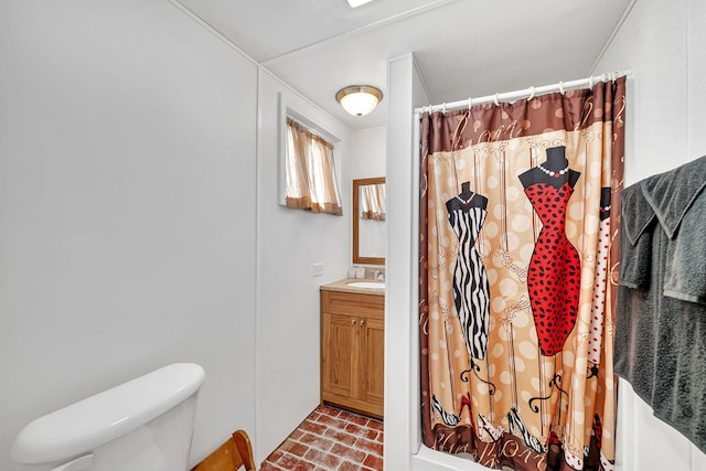 bathroom with brick floor, vanity, toilet, and a shower with curtain