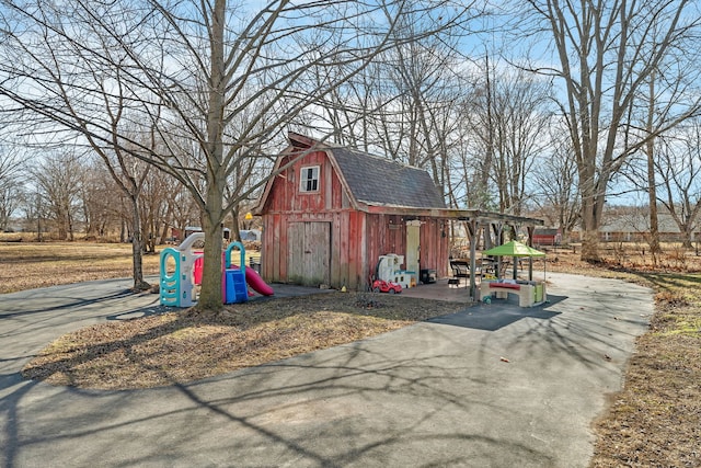 view of barn with a playground