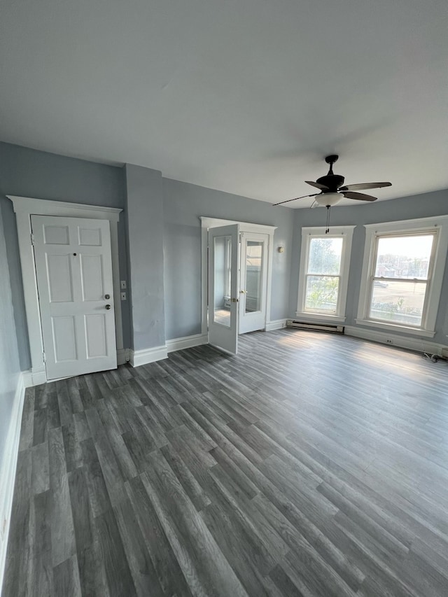 unfurnished living room featuring french doors, dark hardwood / wood-style flooring, baseboard heating, and ceiling fan