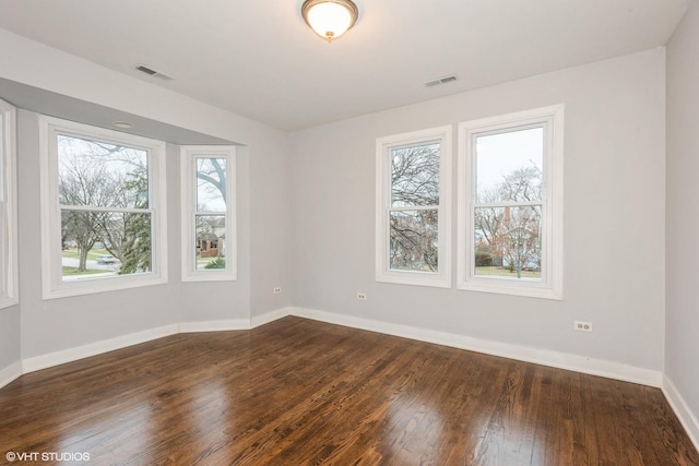 spare room featuring dark hardwood / wood-style floors