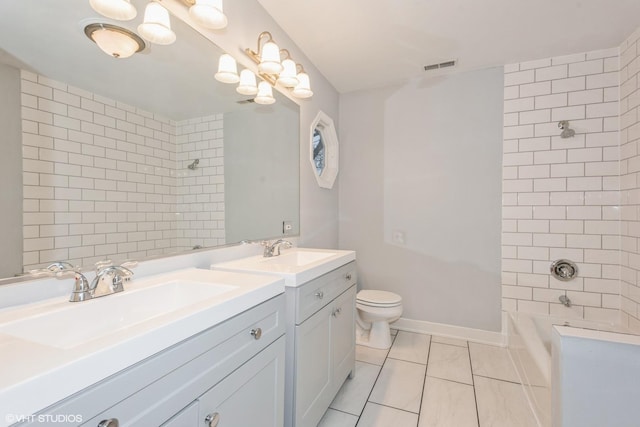 full bathroom featuring toilet, tile patterned flooring, vanity, and tiled shower / bath