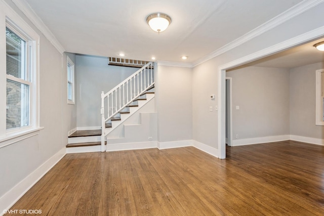 interior space with wood-type flooring, plenty of natural light, and crown molding