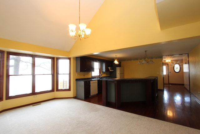 kitchen featuring high vaulted ceiling, decorative light fixtures, white appliances, dark brown cabinetry, and an inviting chandelier