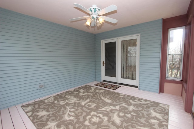 wooden terrace featuring ceiling fan