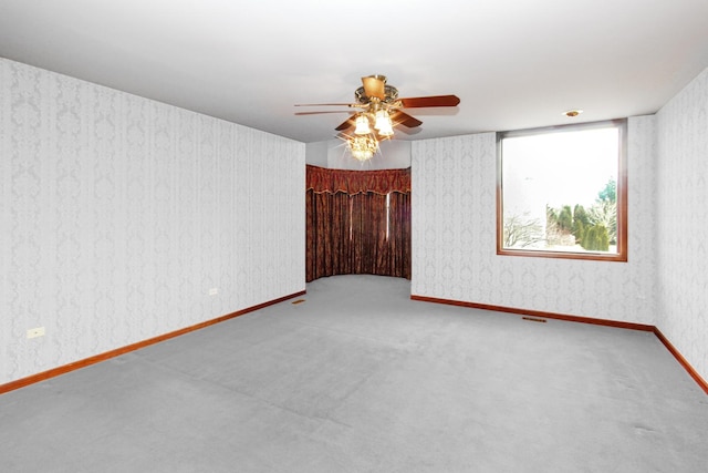 unfurnished room with ceiling fan and carpet flooring