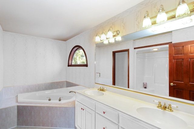 bathroom featuring vanity and tiled bath